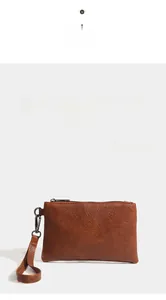 Detail of brown lychee pattern PU leather wallet with zipper closure and wrist strap