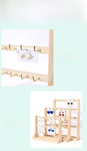 Detail of wooden jewelry display stand with golden metal hooks for earrings and necklaces