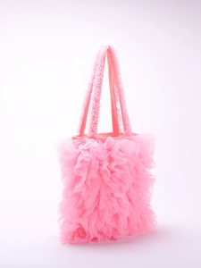 Close-up of pink layered mesh ruffles and soft gauze texture on a stylish tote bag