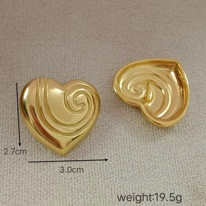 Detail view of gold heart earrings with spiral texture and 2.7cm by 3.0cm size display