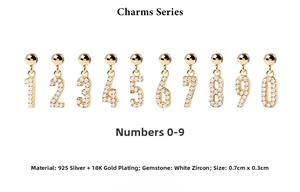 Detail of 925 sterling silver gold-plated charms featuring sparkling cubic zirconia