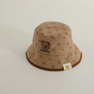 Detail of baby corduroy bucket hat showing brown bear embroidery and ribbed texture