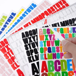 Alphabet letter stickers in various colors with tweezers showing peel-off adhesive