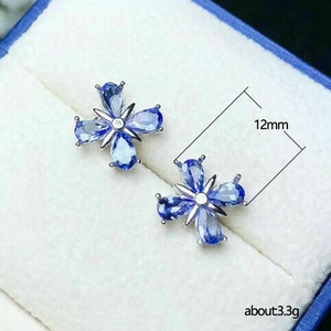 Elegant floral stud earrings with blue pear-cut stones and white zircon centers