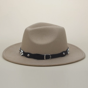 Detail of camel wool fedora hat featuring black leather band with silver studs and white flowers