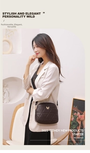 Detail of cross-body shell bag with golden butterfly buckle and quilted faux leather texture