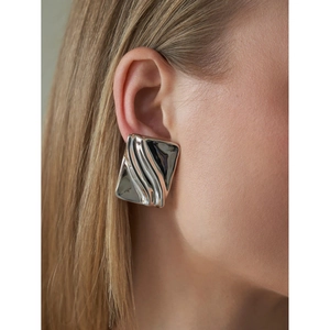 Polished silver stainless steel rectangle earrings with 3D wave texture on model
