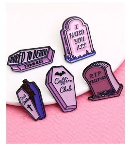 Detailed view of Gothic Halloween enamel pins with Coffin Club and Dead Inside slogans
