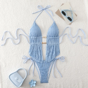 Detailed view of light blue ribbed fabric swimsuit with stylish cut-outs and bead accents