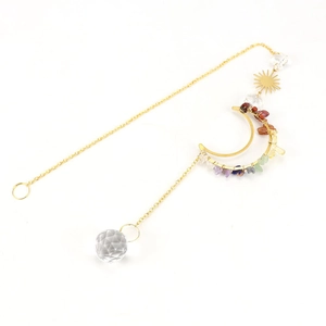 Detailed view of sun and moon crystal suncatcher with natural purple and green gemstones