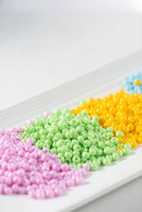 Macro view of 4mm painted glass round beads in assorted colors for DIY jewelry making