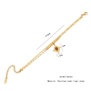 Detailed view of gold multi-layer stainless steel bracelet with tiger eye stone pendant