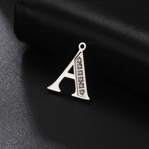 Polished stainless steel letter A pendant with sparkling diamonds on black background