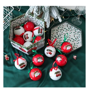 Close-up of red and white Christmas balls with holiday patterns in a hexagonal gift box