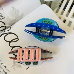 Close-up of high-quality acrylic UFO spaceship hair claws with strong metal springs