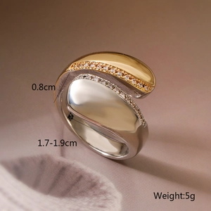 Detail view of two-tone geometric ring showing 1.7-1.9cm inner diameter and 5g weight