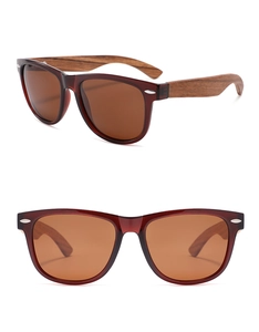 Detail of burgundy oval sunglasses with natural wood temples and brown polarized lenses