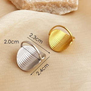 Oval gold and silver stainless steel rings with radial texture and minimalist design