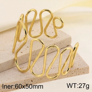 Detailed view of gold wavy cuff bracelet on a stone pedestal with size specifications