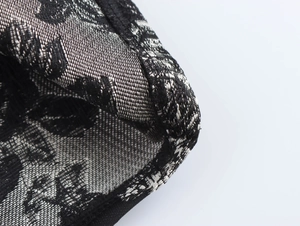Detailed macro shot of vintage black and white jacquard fabric texture and pattern