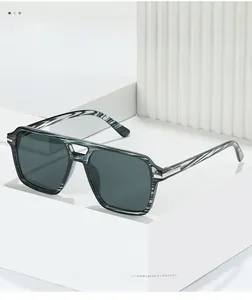 Detail of square double-bridge sunglasses with blue marble texture and dark grey lenses