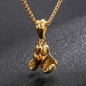 Detailed close-up of 316L stamp on gold-plated stainless steel boxing glove pendant
