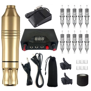 Close-up of golden rotary tattoo pen with digital power supply and full accessory kit