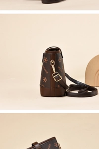 Detailed close-up of brown bucket bag featuring MOCKDE monogram print and adjustable strap