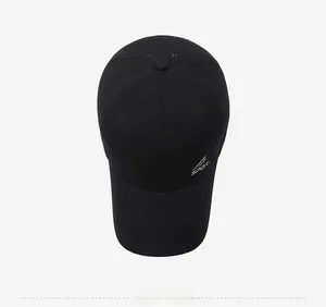 Close-up of black breathable baseball cap with laser-cut holes and white sports logo