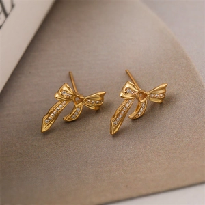 Macro shot of 18K gold plated bow earrings with heart cutout and micro-inlaid zircon