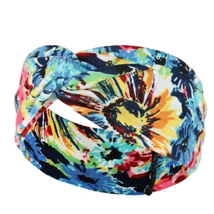Detail view of the colorful floral paisley print and knot design on this elastic yoga headband