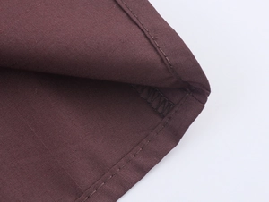 Detailed close-up showing the precise stitching and chestnut brown fabric texture