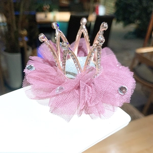 Close-up of pink mesh veil and sparkling rhinestone crown hairpin for children