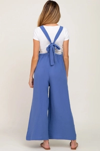 Detail of blue wide-leg maternity jumpsuit with decorative back-tie and textured fabric