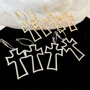 Textured hollow cross pendant hoop earrings in metallic gold and silver finish