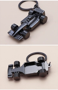 Detail of a gunmetal zinc alloy F1 racing car keychain showing precise model structure