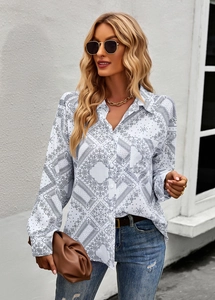 Detail of white long-sleeved shirt with black paisley pattern and button-down collar