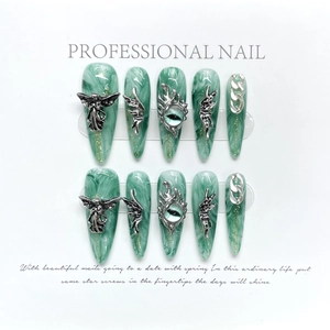 Handmade Y2K stiletto press-on nails with green marble texture and 3D silver angel charms