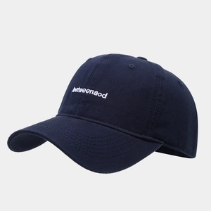 Detailed view of the navy blue cotton twill baseball cap with white letter embroidery