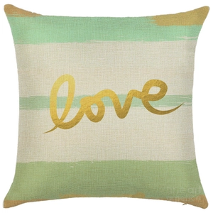 Close-up of linen pillowcase with green stripes and golden love print detail
