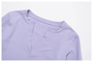 Close-up of a light purple yoga top featuring a sleek V-neckline and durable stitching