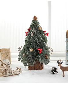 Close-up of mini Christmas tree with red berries, pine cones and natural wood base