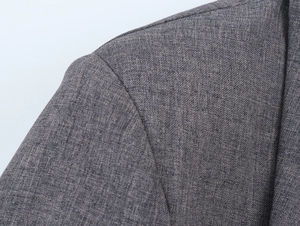 Close-up of gray blazer shoulder showing high-quality blended fabric texture and stitching