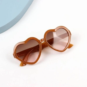 Detail of brown glitter heart-shaped sunglasses with stylish brown gradient lenses