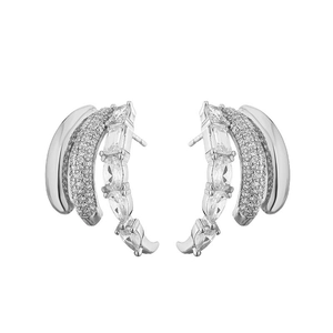 Macro detail of silver-tone multi-layer C-shaped stud earrings with sparkling cubic zirconia