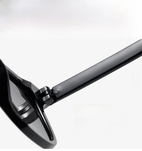 Detail showing the sturdy metal hinge and polished black frame of these square sunglasses
