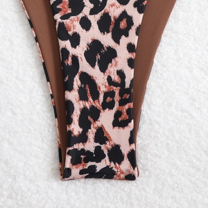 Close-up of leopard print bikini fabric with smooth elastic texture and neat edge stitching