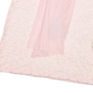 Detail view of pink floral lace fabric stitched with delicate mesh on a bodycon dress