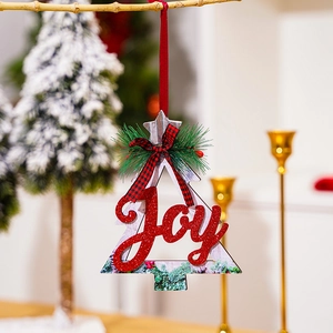 Detail view of a wooden Christmas tree ornament featuring red glitter Joy lettering