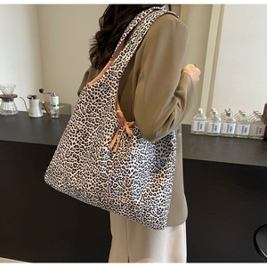 Detail of leopard print canvas tote bag featuring large capacity and stylish bow shoulder strap